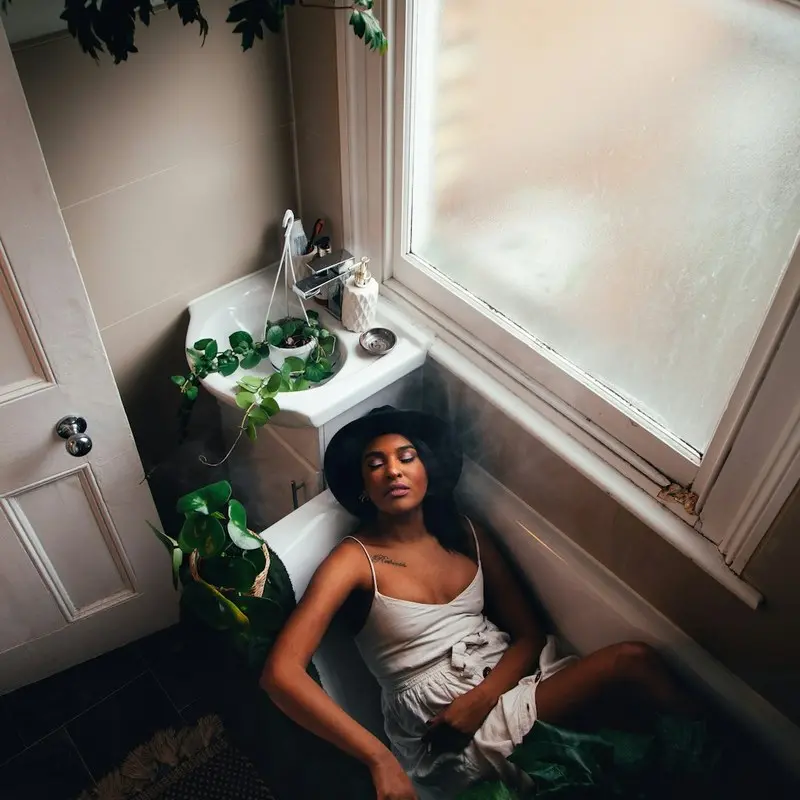 Woman following a peaceful morning self-care routine in a bright bathroom