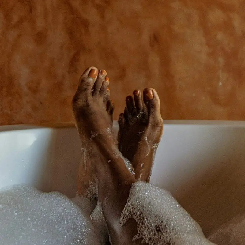 How to Build a Self-Care Routine You'll Actually Stick To 5 Person relaxing in a bath for home spa wellness routine